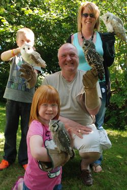 a family enjoying the exprience of meeting Owls-4-u